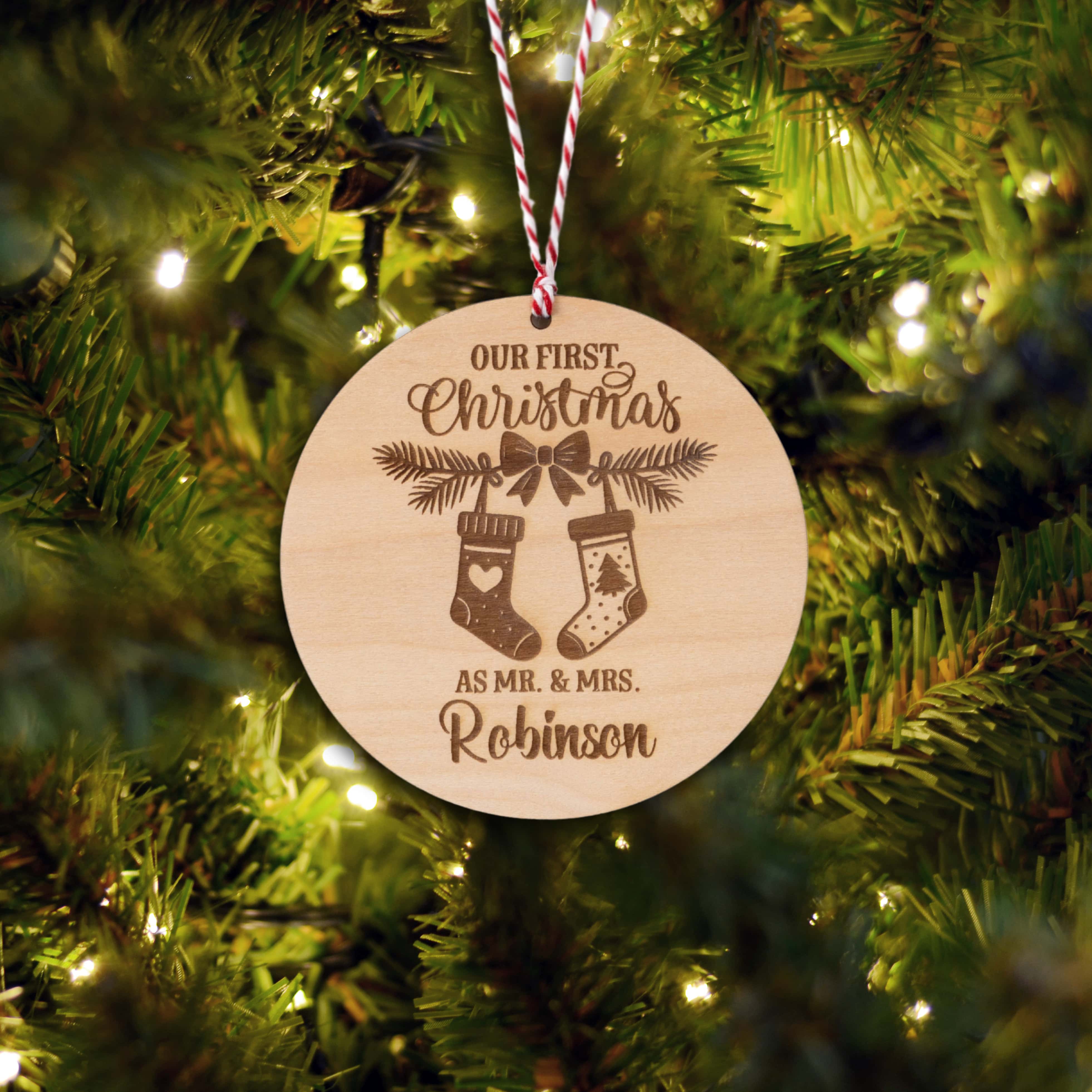 Personalised Couples Christmas Ornament featuring stockings and names on a wooden tree bauble.