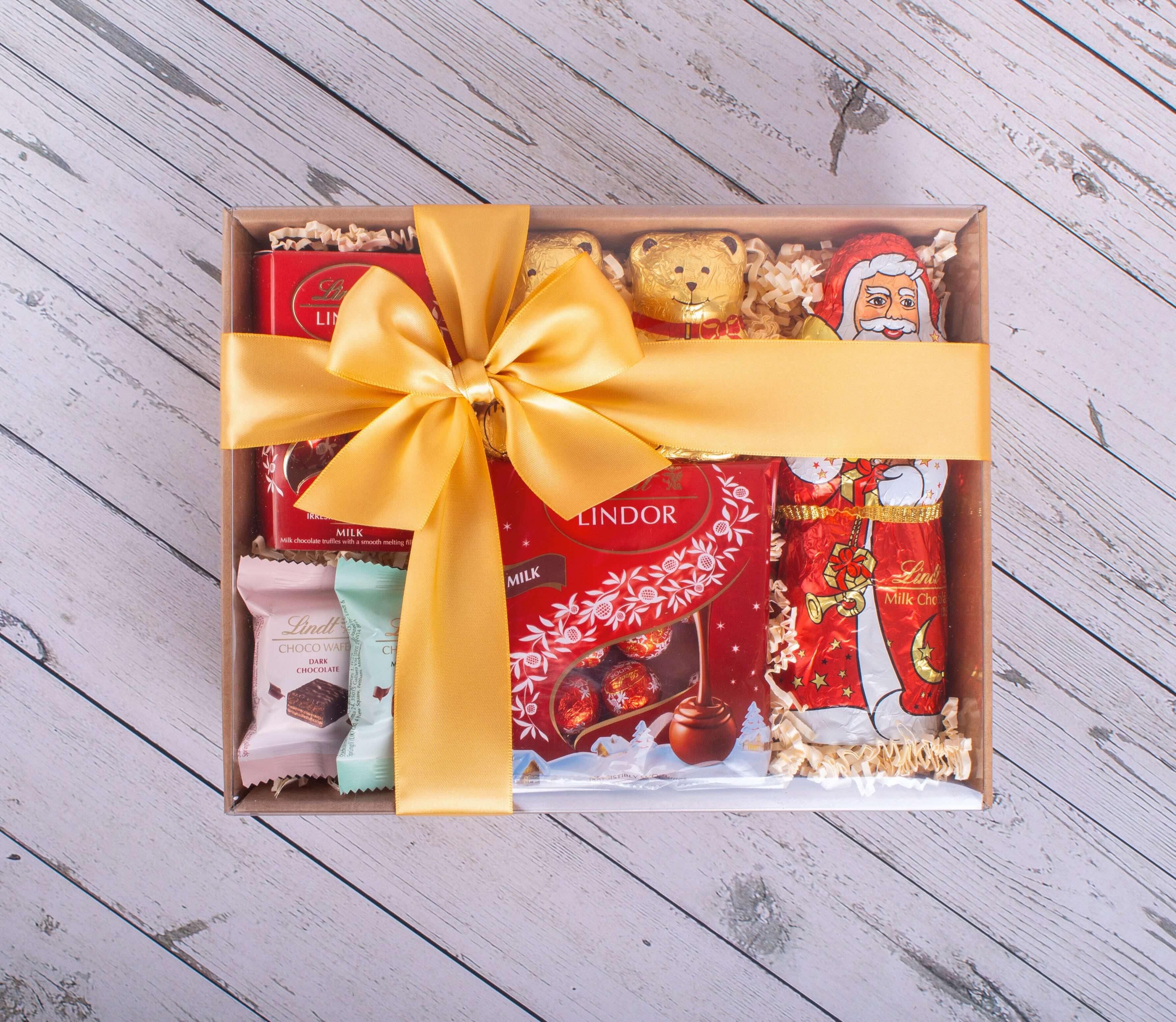 Christmas Lindt Santa Hamper with assorted chocolates and festive bow.