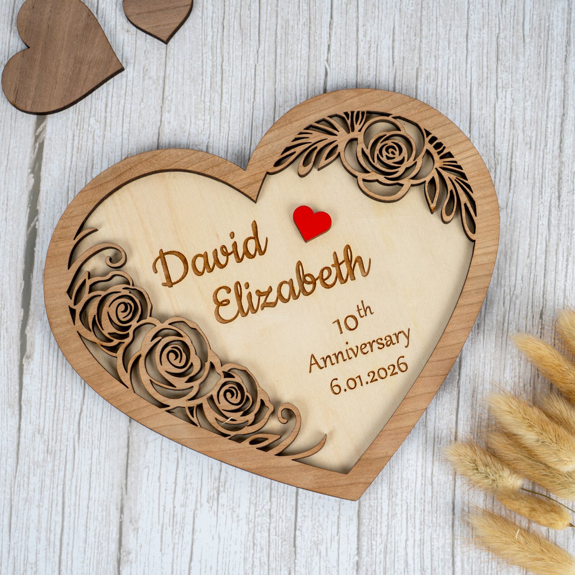 Personalised wooden heart plaque featuring names David and Elizabeth, celebrating their 10th Anniversary.