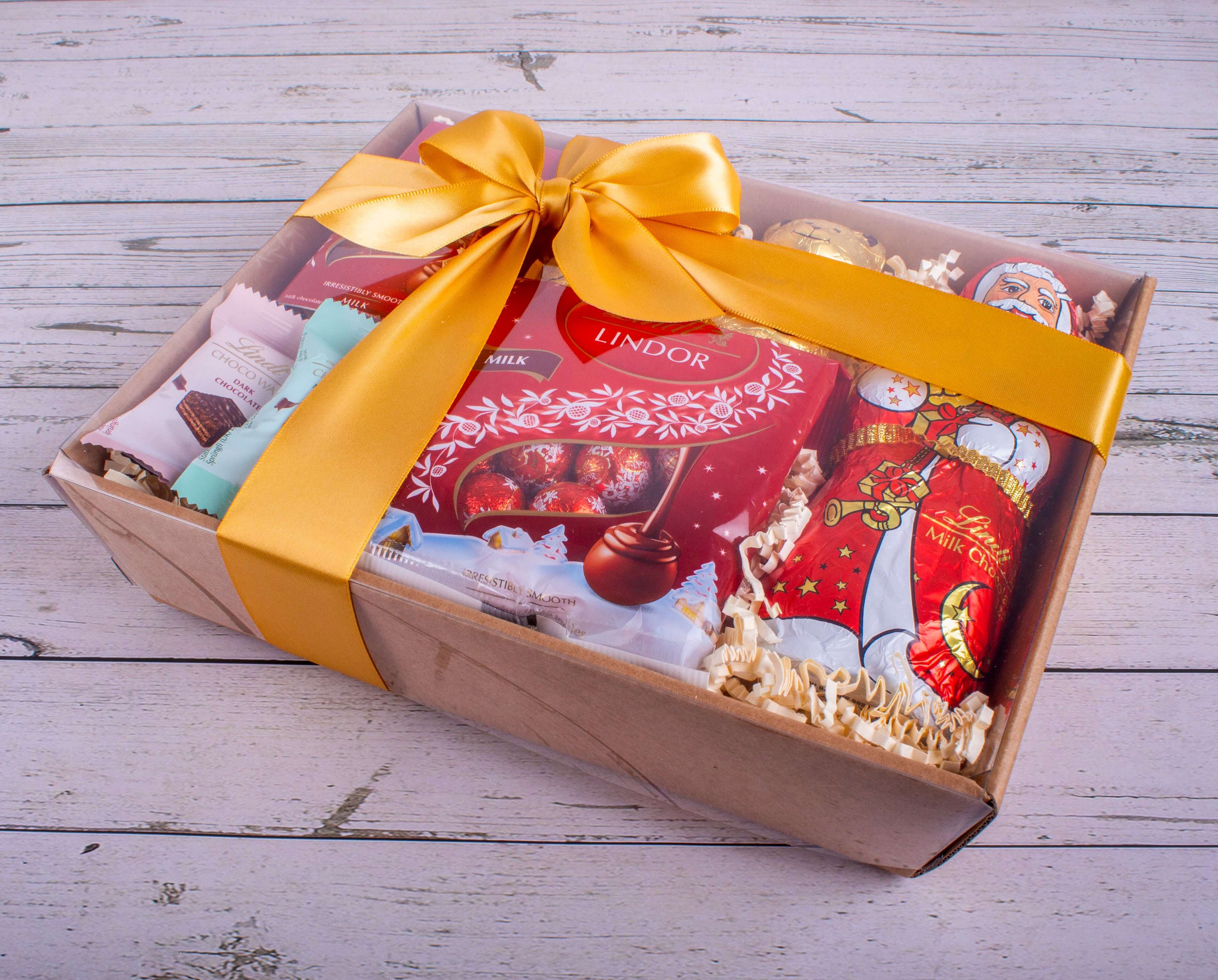 Christmas Lindt Santa Hamper filled with assorted chocolates, beautifully wrapped with a yellow ribbon.