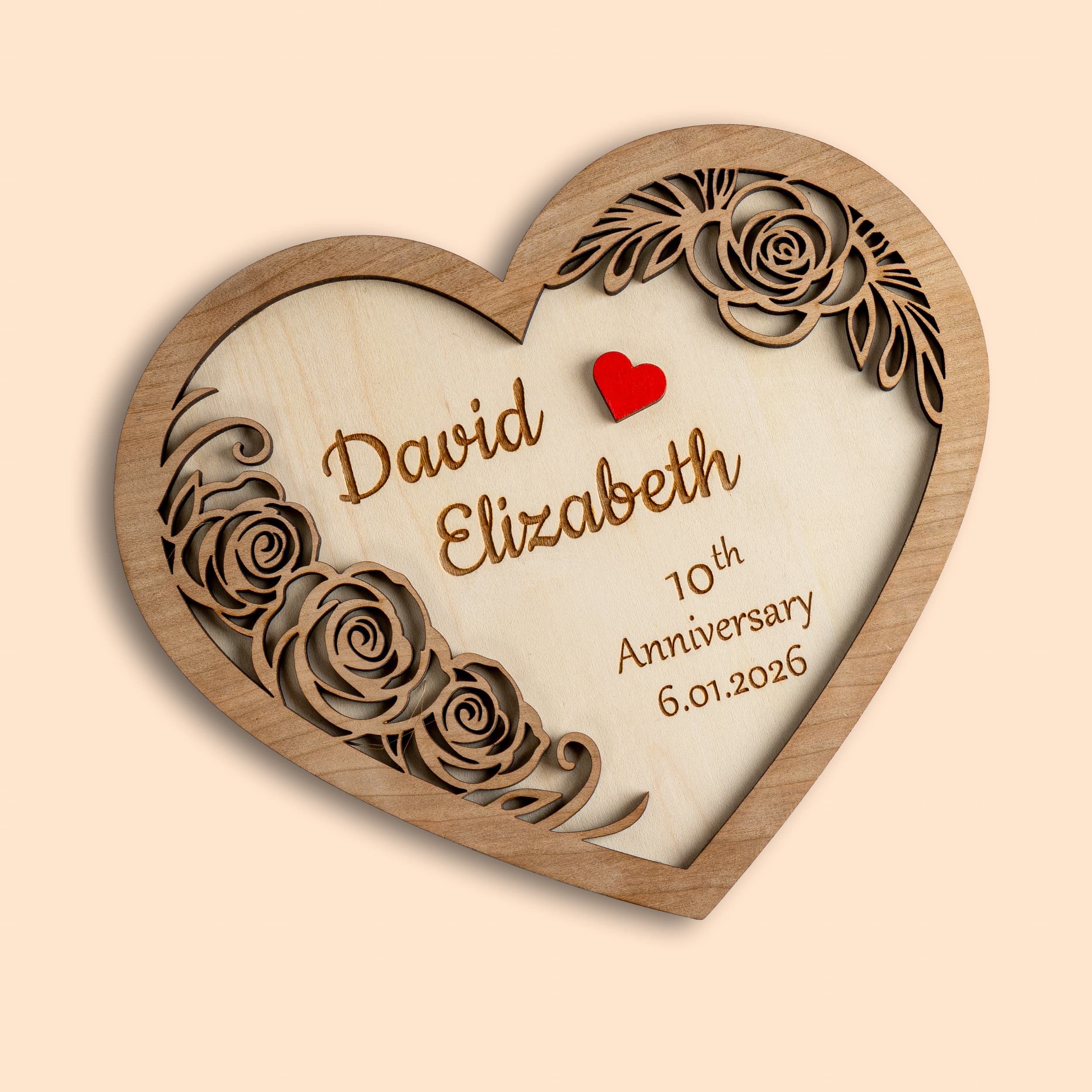 Personalised wooden heart plaque featuring names and anniversary date, perfect gift for love celebrations.