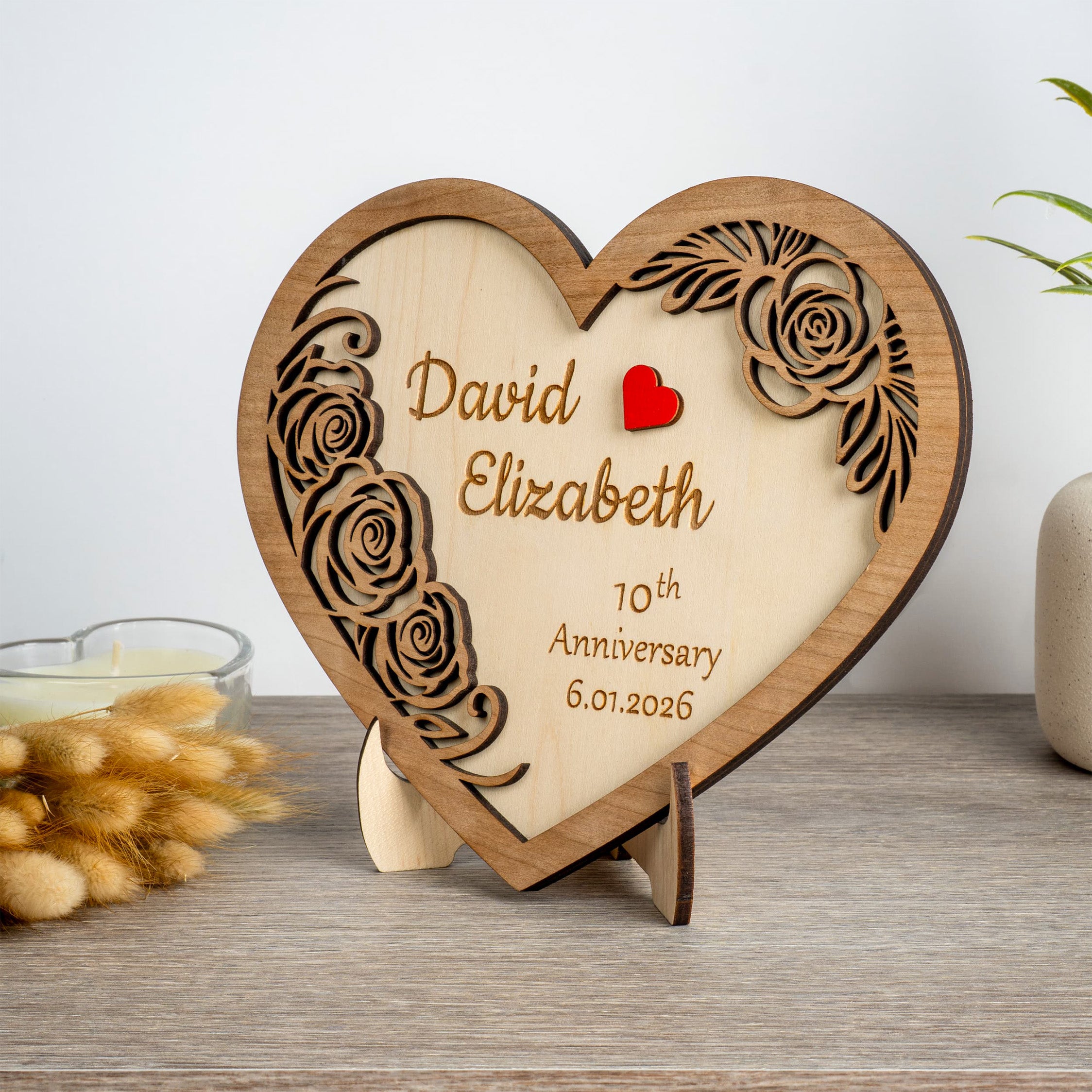 Personalised wooden heart plaque featuring names and anniversary date, beautifully crafted from wood.