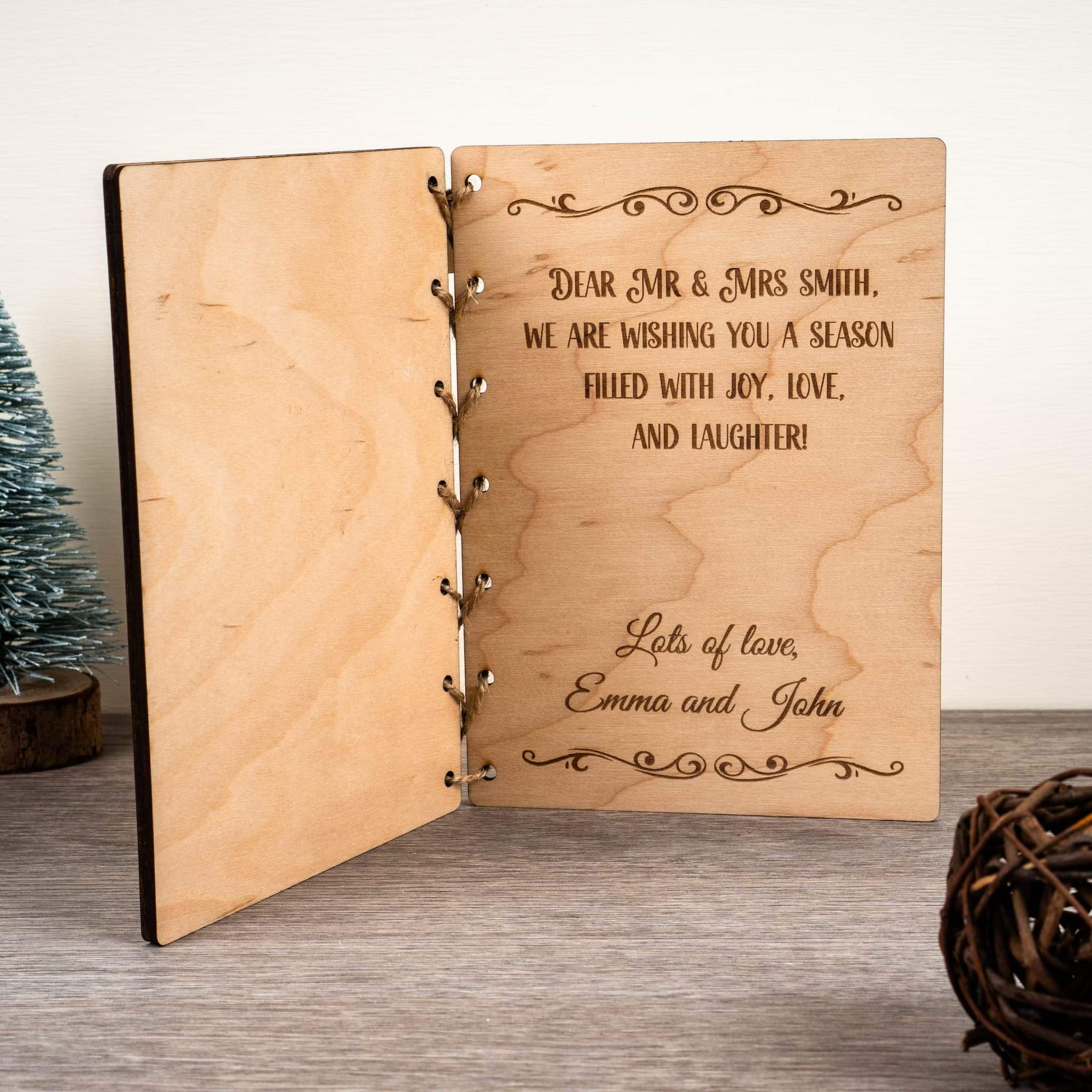 Personalised Christmas Card featuring engraved text wishing joy, love, and laughter for the holiday season.