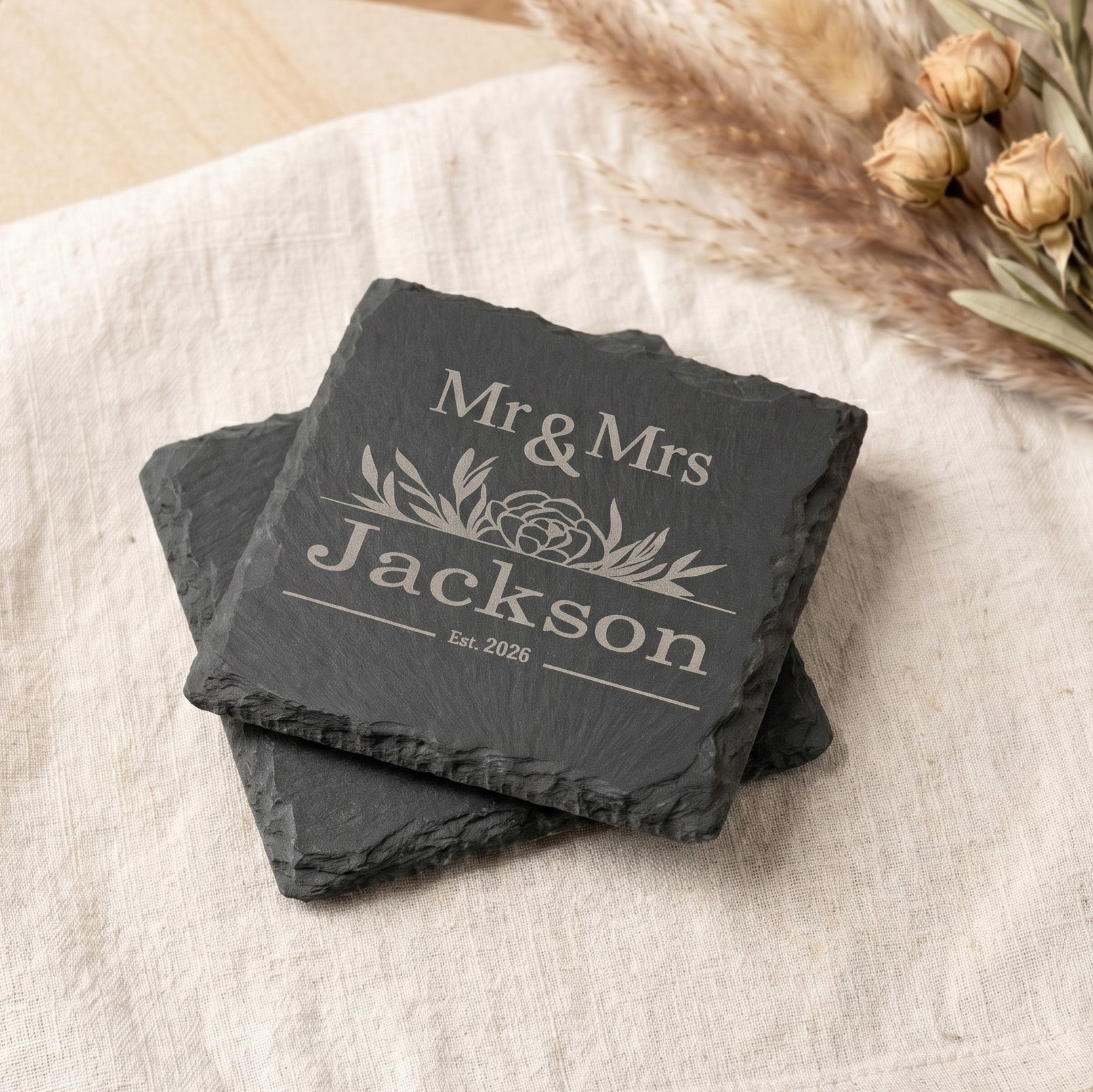 Personalised Slate Coaster Set featuring engraved names Mr & Mrs Jackson with floral design and establishment year 2026.