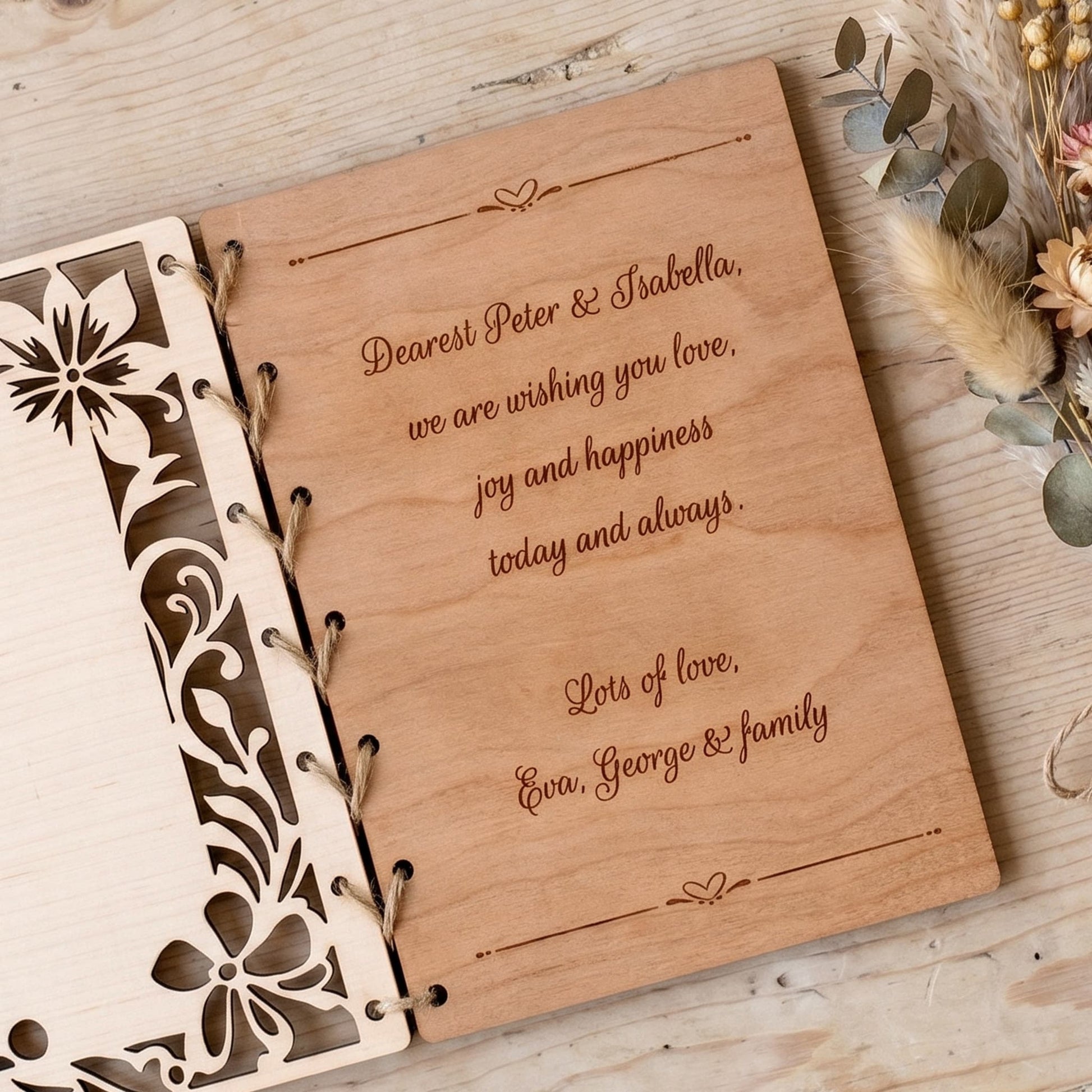 Wooden wedding card with engraved text on a wooden surface with decorative elements.
