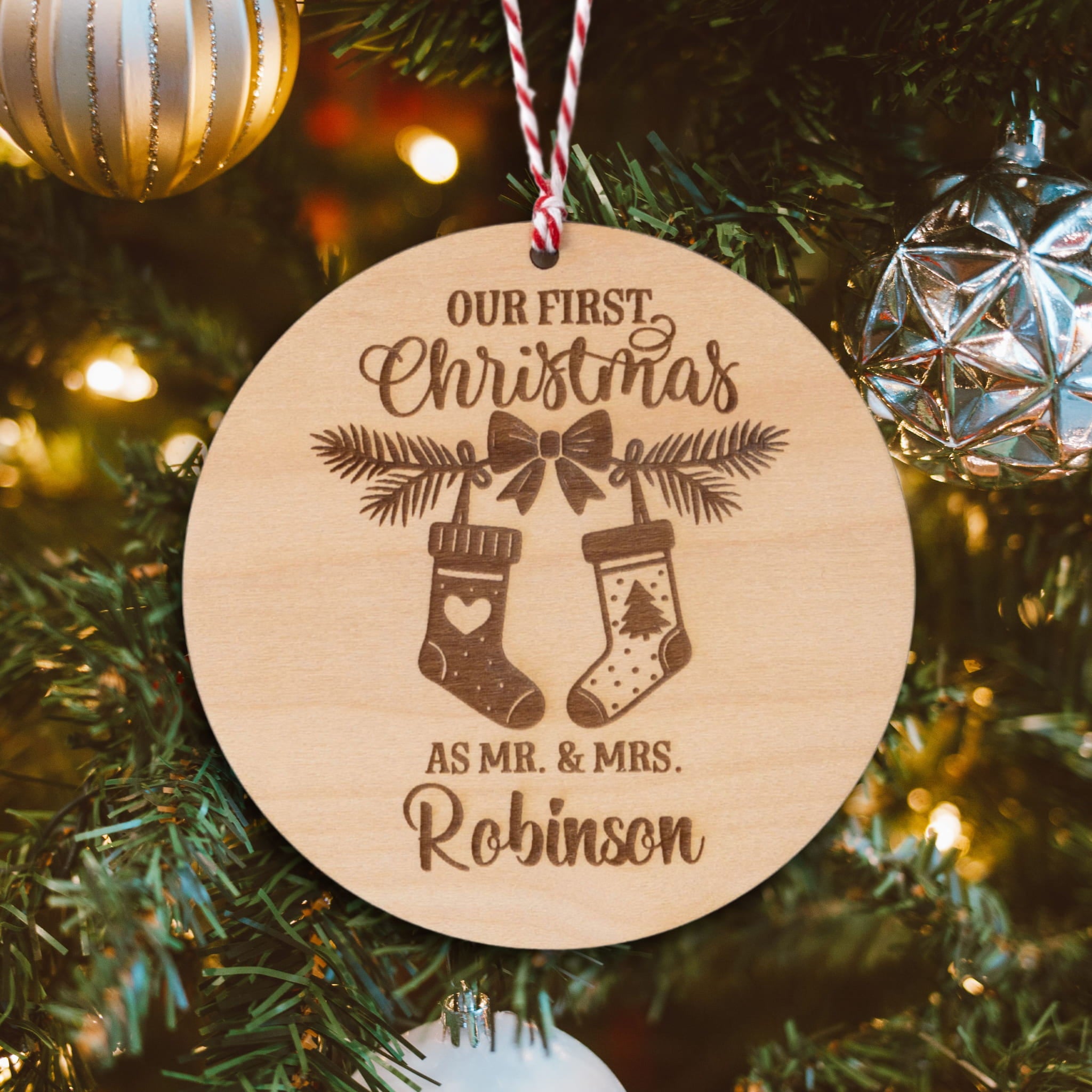 Personalised Couples Christmas Ornament featuring stockings and names on a wooden tree bauble.