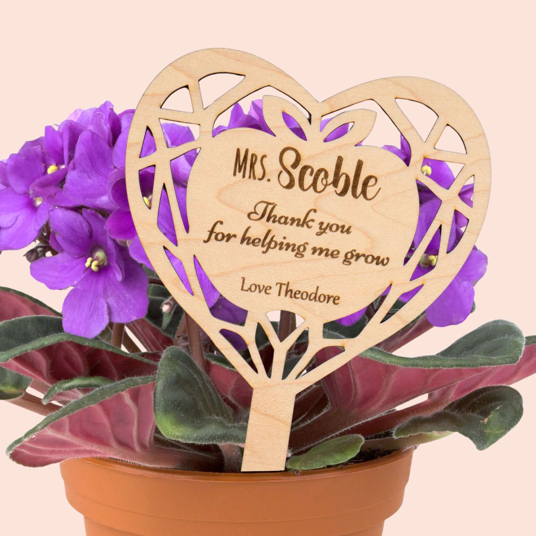 Personalised flower pot sign for teachers with heartfelt message and floral pot in the background.